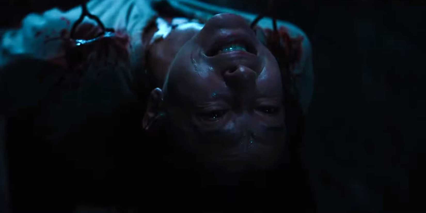 Nora being held up by the hooked chains of the Hell Priest in Hellraiser (2022)
