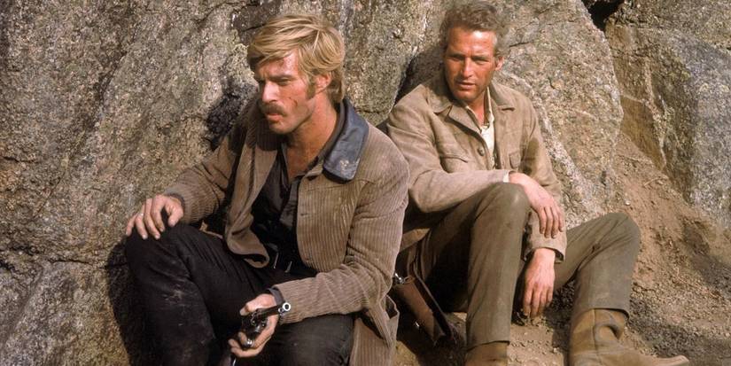 Paul Newman and Robert Redford hiding behind a rock in Butch Cᴀssidy and the Sundance Kid