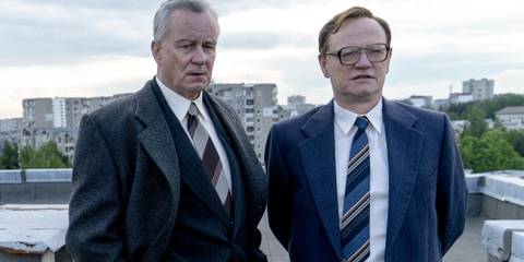 Two men stand on a roof in Chernobyl 