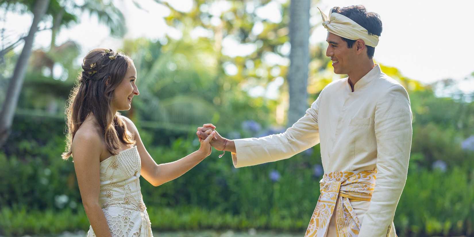 Lily and Gede holding hands on their wedding day in Ticket to Paradise