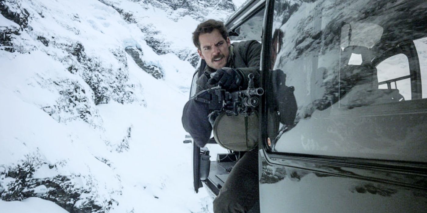 Henry Cavill as August Walker in Mission Impossible Fallout, firing a gun while leaning out of a moving vehicle