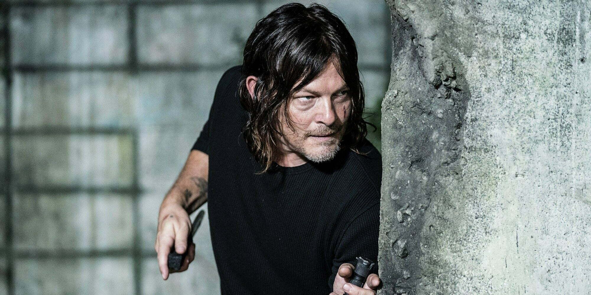 Norman Reedus as Daryl Dixon holding a knife in The Walking Dead season 11