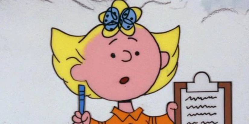 An image of Sally Brown holding up a pen and a clipboard with squiggles of writing on it.