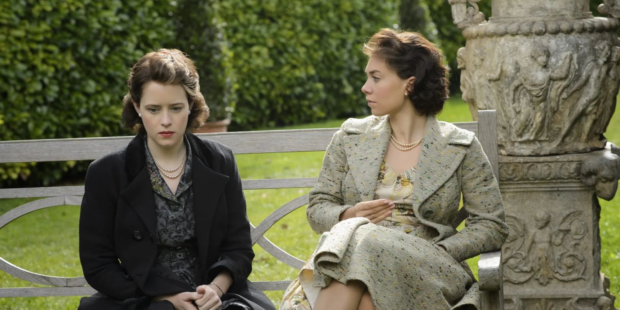 The Crown: Queen Elizabeth (Claire Foy) and Princess Margaret (Vanessa Kirby) sit on a bench