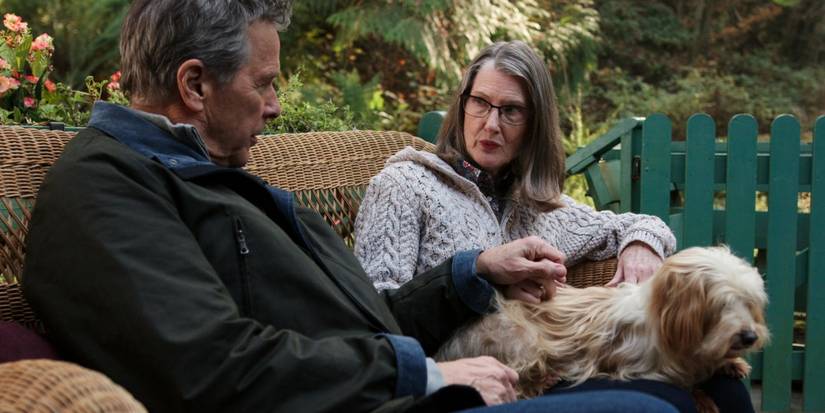 Doc and Hope sitting with their dog in Virgin River