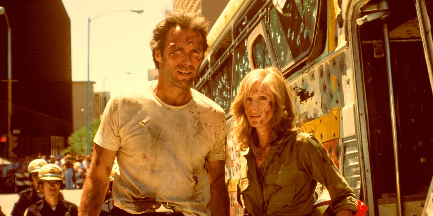 Clint Eastwood and Sondra Locke looking tattered beside the bullet riddled bus in The Gauntlet