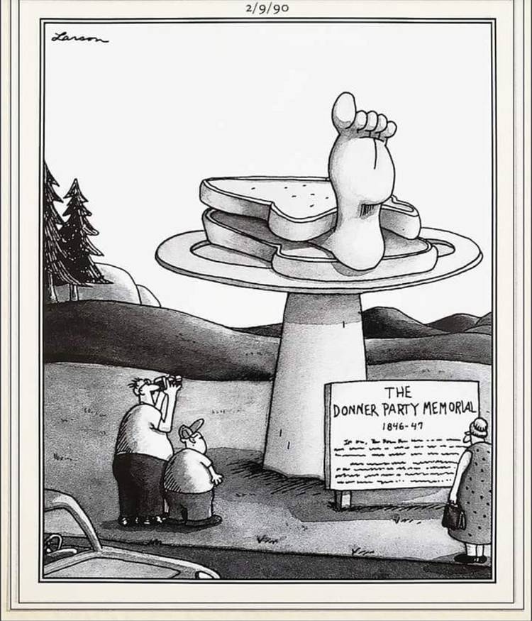 People take pictures of a statue of a human foot in a sandwich. The sign at the bottom of the statue says "The Donner Party Memorial".
