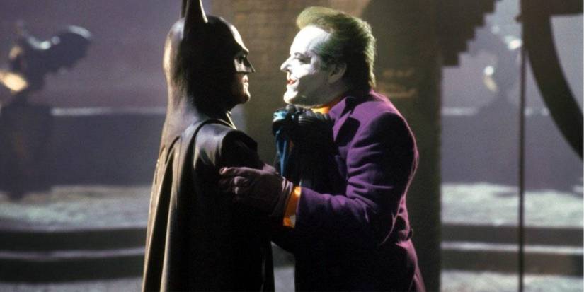 Batman (Keaton) holds Joker (Nicholson) by the collar in Batman (1989)