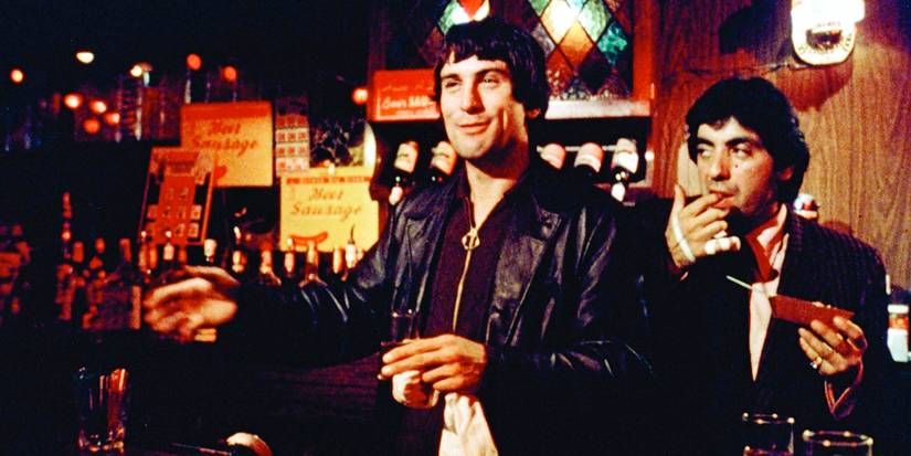Robert De Niro as Johnny Boy, grinning in a bar in Mean Streets