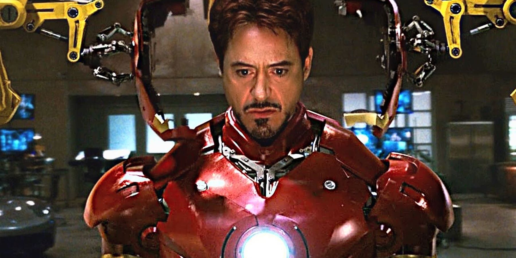 Robert Downey Jr as Tony Stark putting on the Iron Man suit in Iron Man (2008)