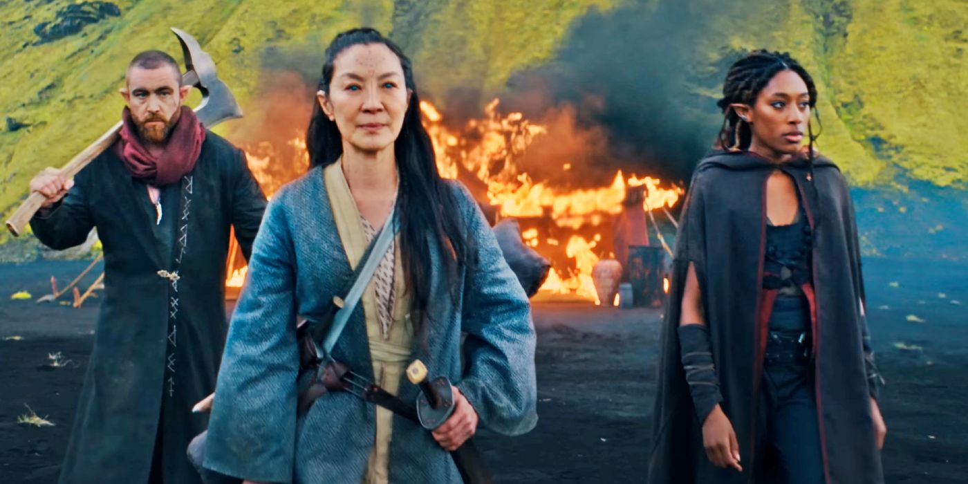 Scian (Michelle Yeoh), Éile (Sophia Brown), Fjall (Laurence O'Fuarain) walking past a large fire in The Witcher: Blood Origin.