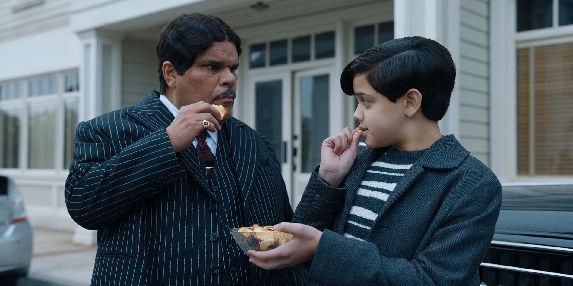 Gomez and Pugsley Addams eating in Wednesday season 1