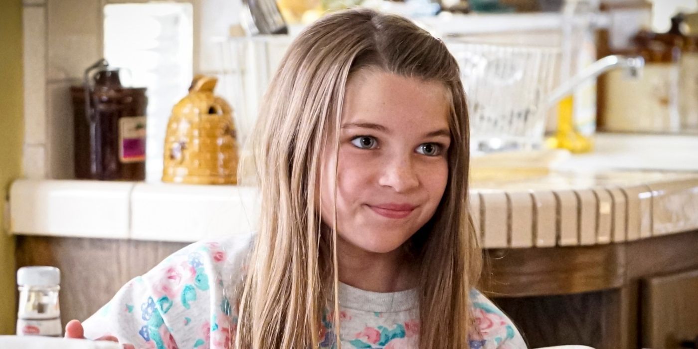 Missy from Young Sheldon smirking while at the table eating
