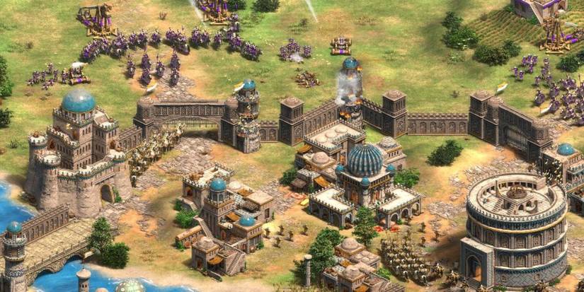 A castle settlement with soldiers outside of it in Ages of Empires 2.