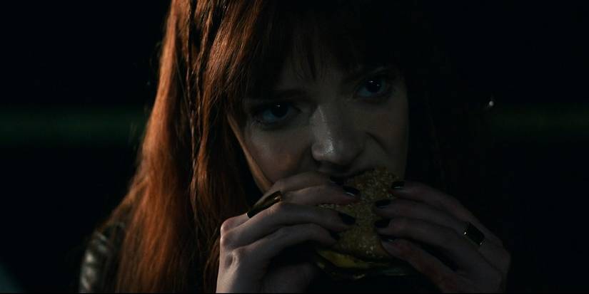 Anya Taylor-Joy's Margot in The Menu's closing scene eating a cheeseburger