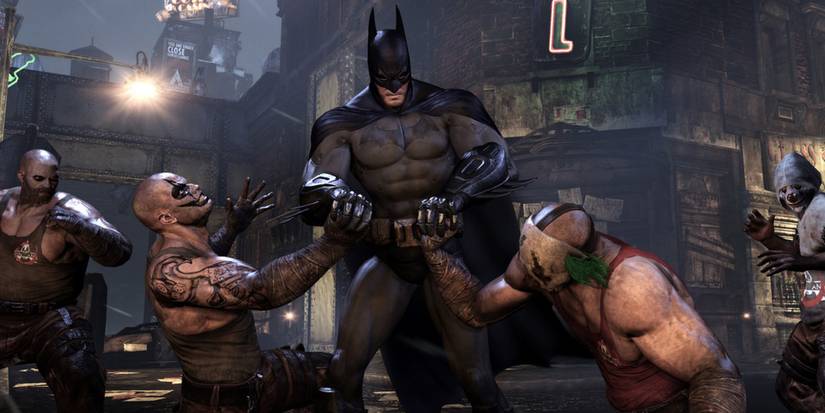 A screenshot from Batman: Arkham City showing the Dark Knight fighting some Joker minions.