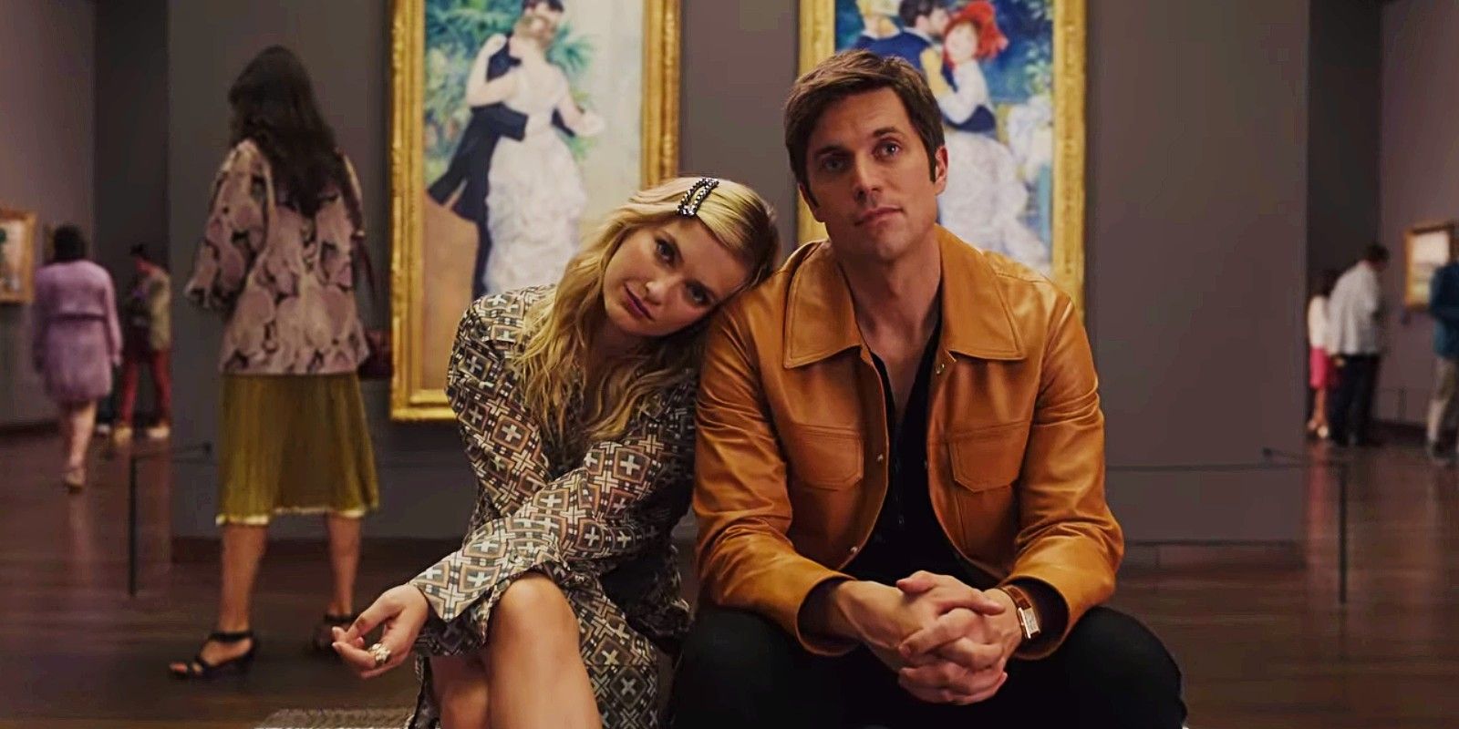 Camille sits with her head against Gabriel's shoulder in an art museum in Emily in Paris