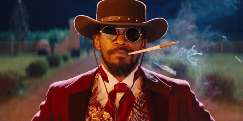 Jamie Foxx as Django watching Candyland burn while smoking a fancy cigarette at the end of Django Unchained