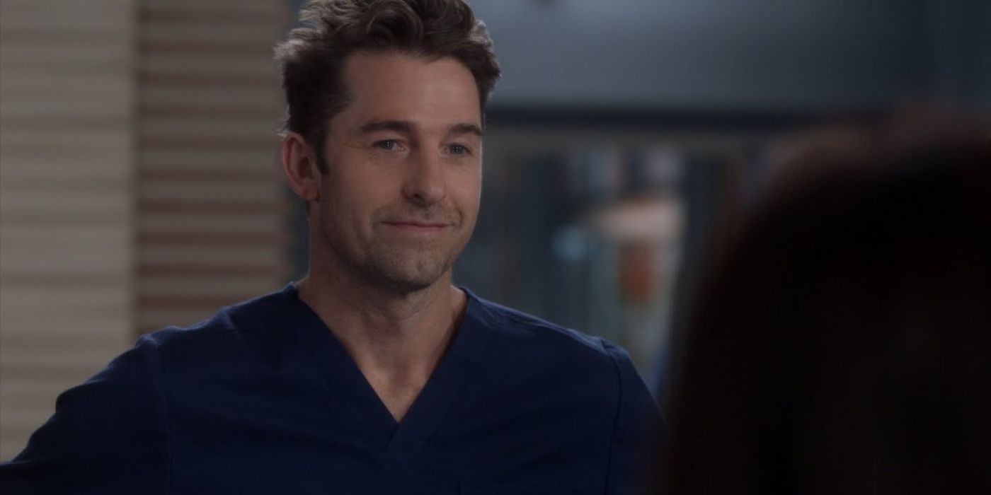 Nick smiling at the hospital in his scrubs on Grey's Anatomy