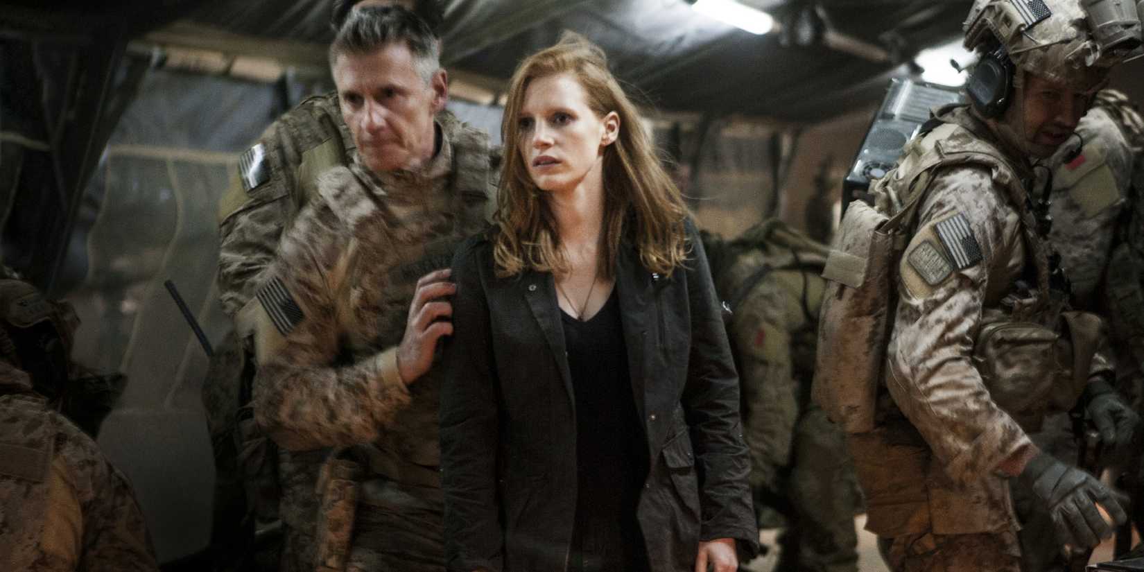 Jessica Chastain as Maya being led through a military plane in Zero Dark Thirty