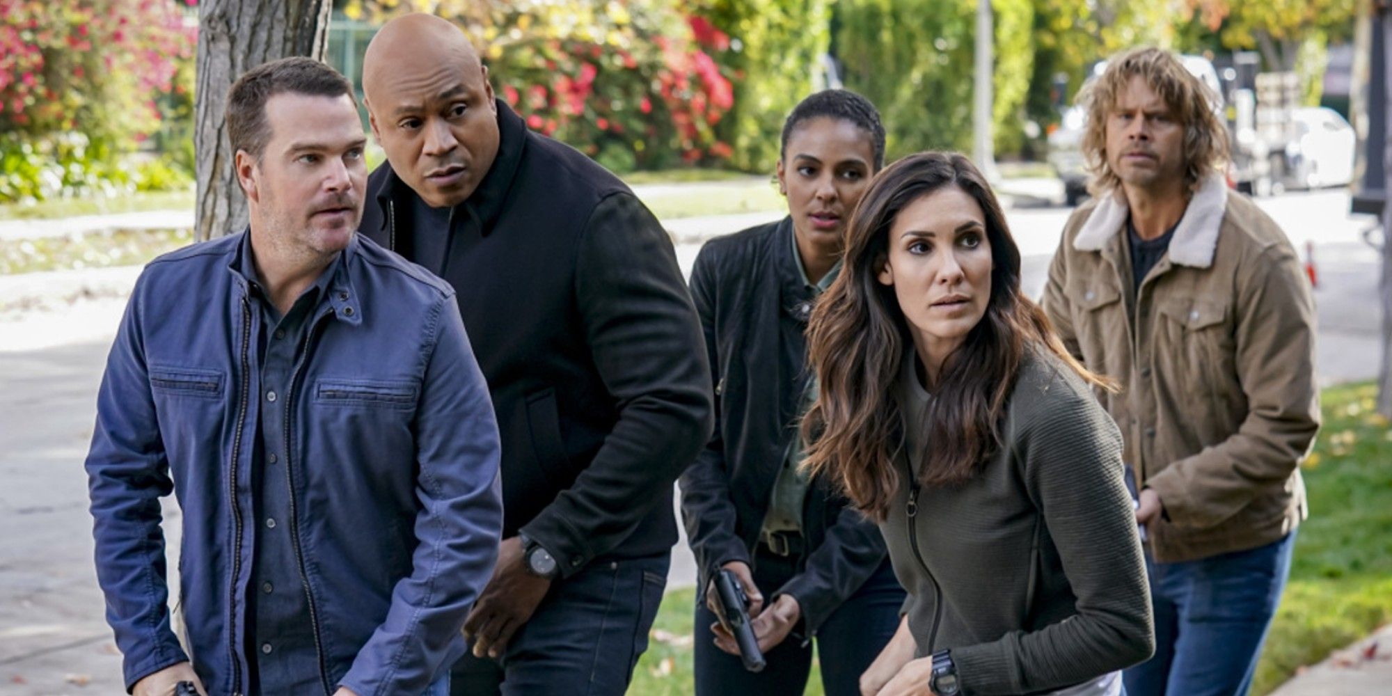 NCIS Los Angela team group up outside a house in season 14