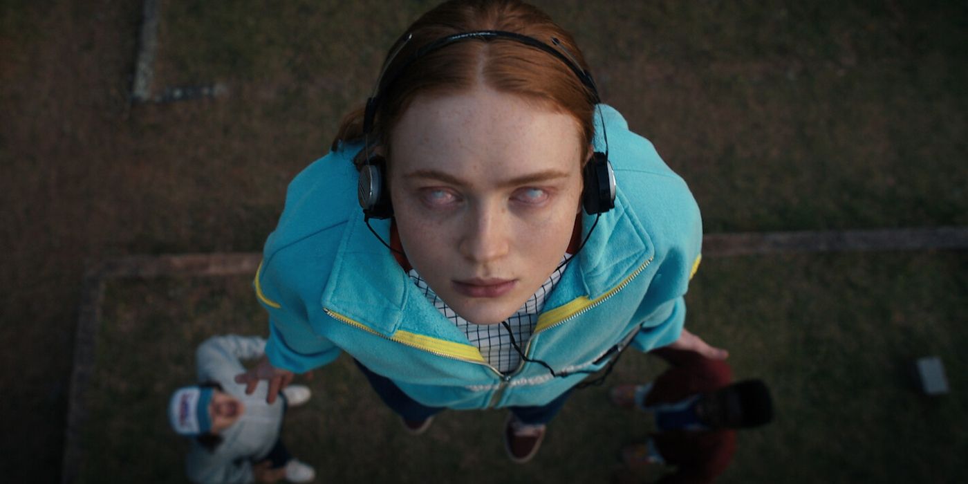 Sadie Sink as Max Mayfield listening to headphones with white eyes on Stranger Things