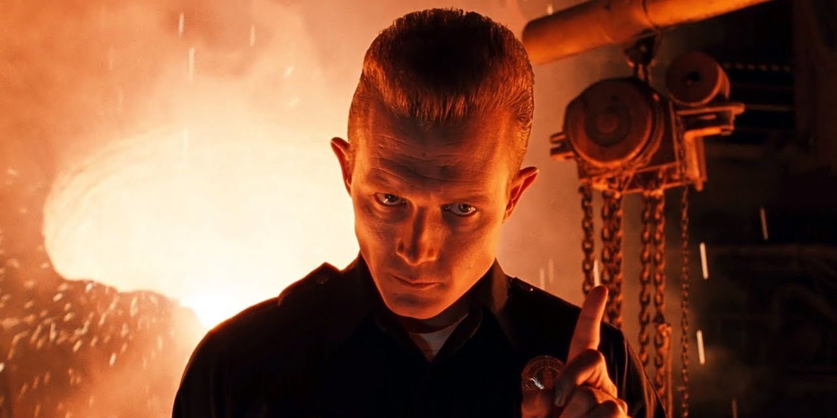 Robert Patrick as T-1000 holding up a finger and looking menacing at the steel mill in Terminator 2: Judgment Day