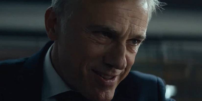 Christoph Waltz as Regus Patoff smirking in The Consultant
