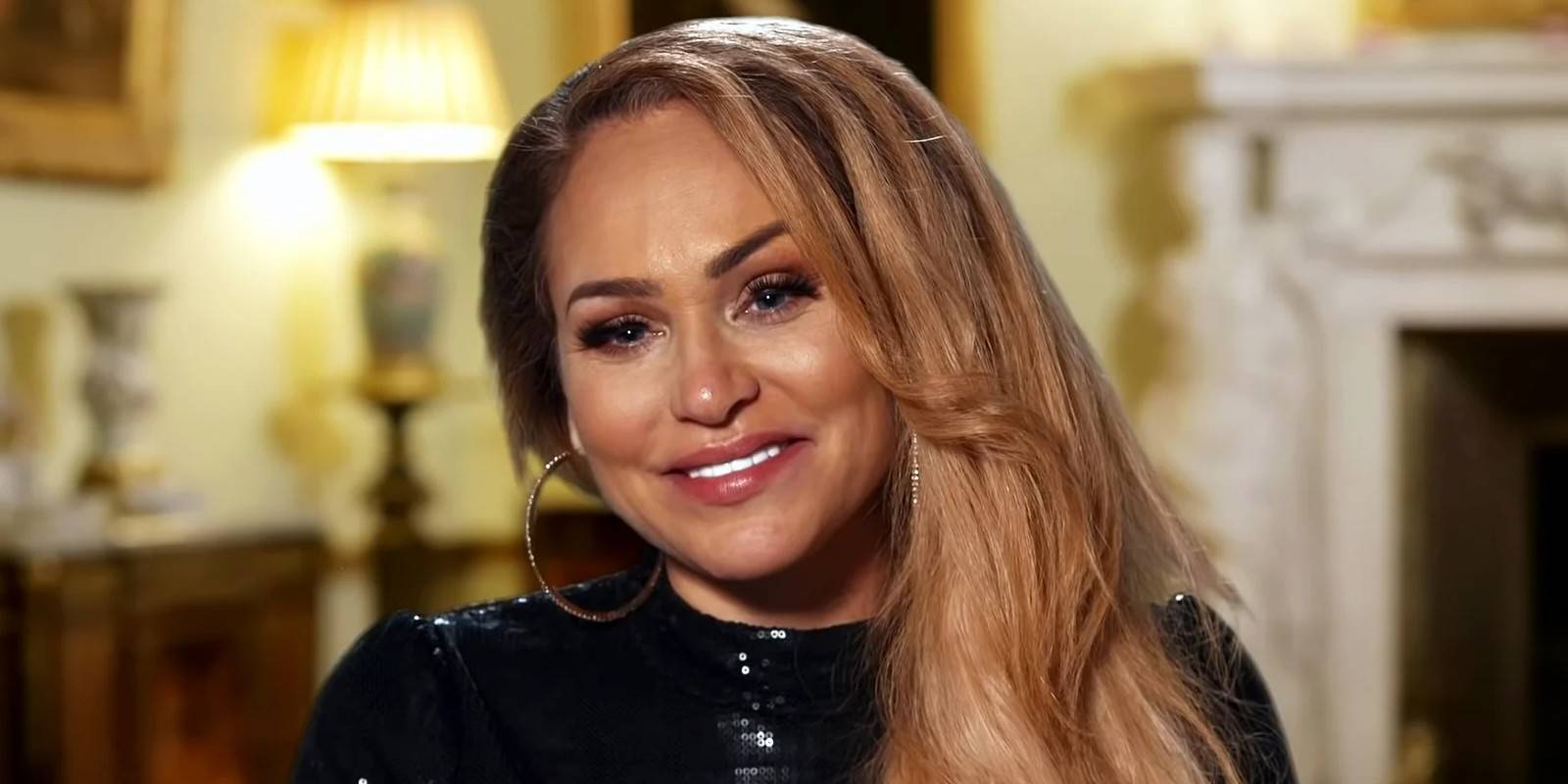 Darcey Silva from 90 Day Fiancé smiling wearing a black dress