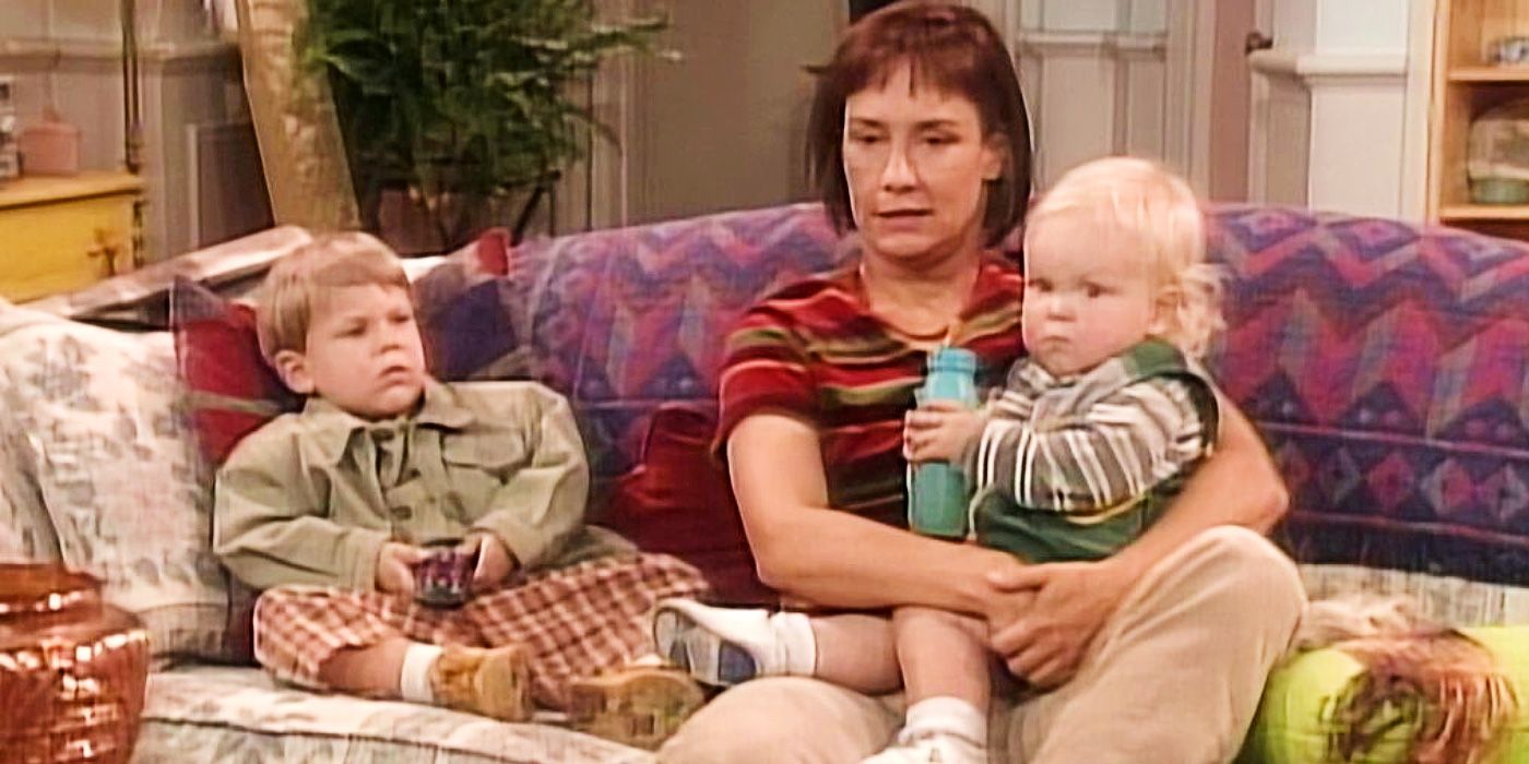 Laurie Metcalf's Jackie sits on a couch with Jerry and Andy in Roseanne