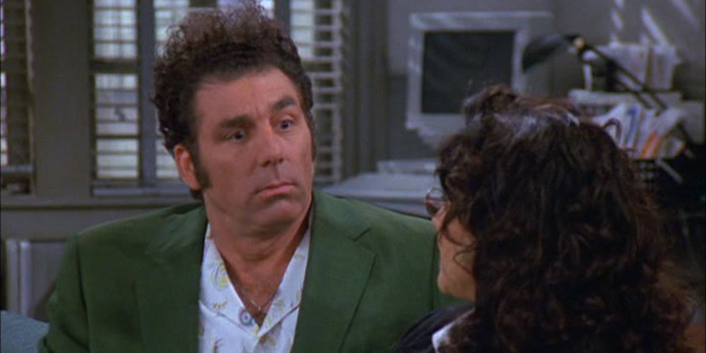 Kramer in Seinfeld expressing shock and dismay while sitting on the couch facing Elaine