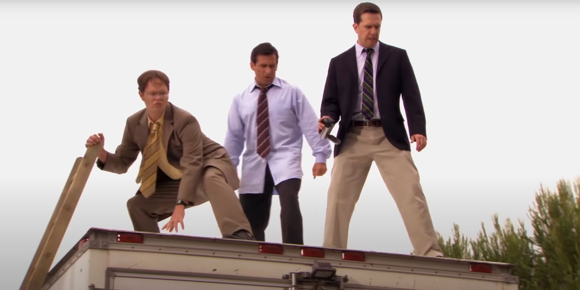 Michael Dwight and Andy from The Office standing on top of truck in parkour cold open