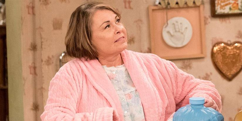 Roseanne Barr sitting at the kitchen table in Roseanne