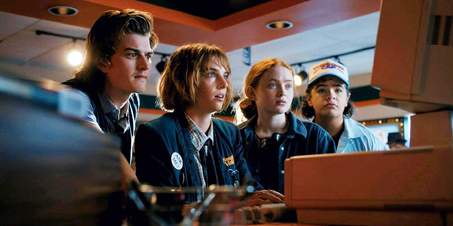 Steve, Robin, Max, and Dustin looking at the computer screen in Stranger Things