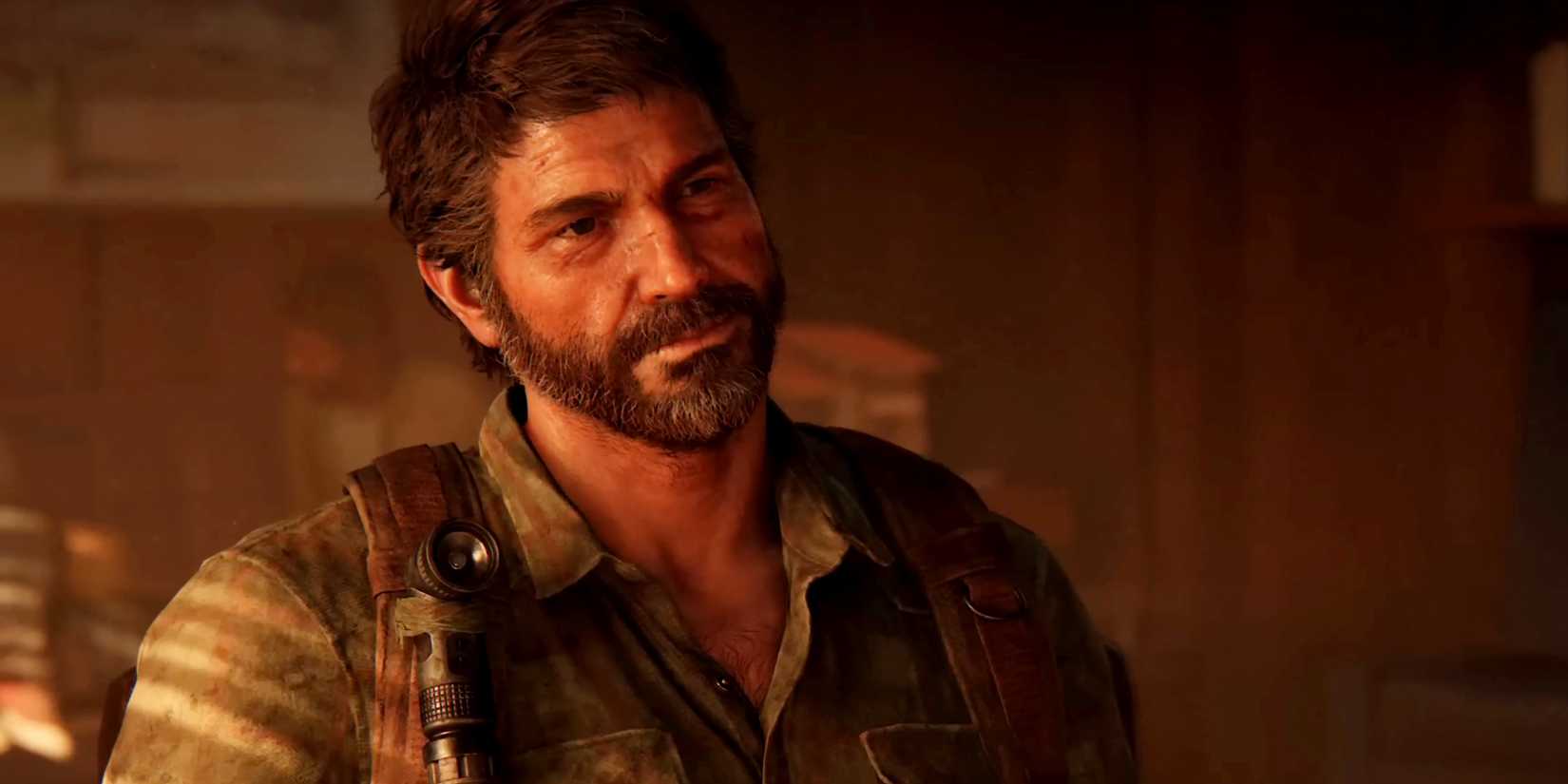 Joel from The Last of Us Part 1, sitting in a chair while he talks to Henry, who is out of frame to the right.