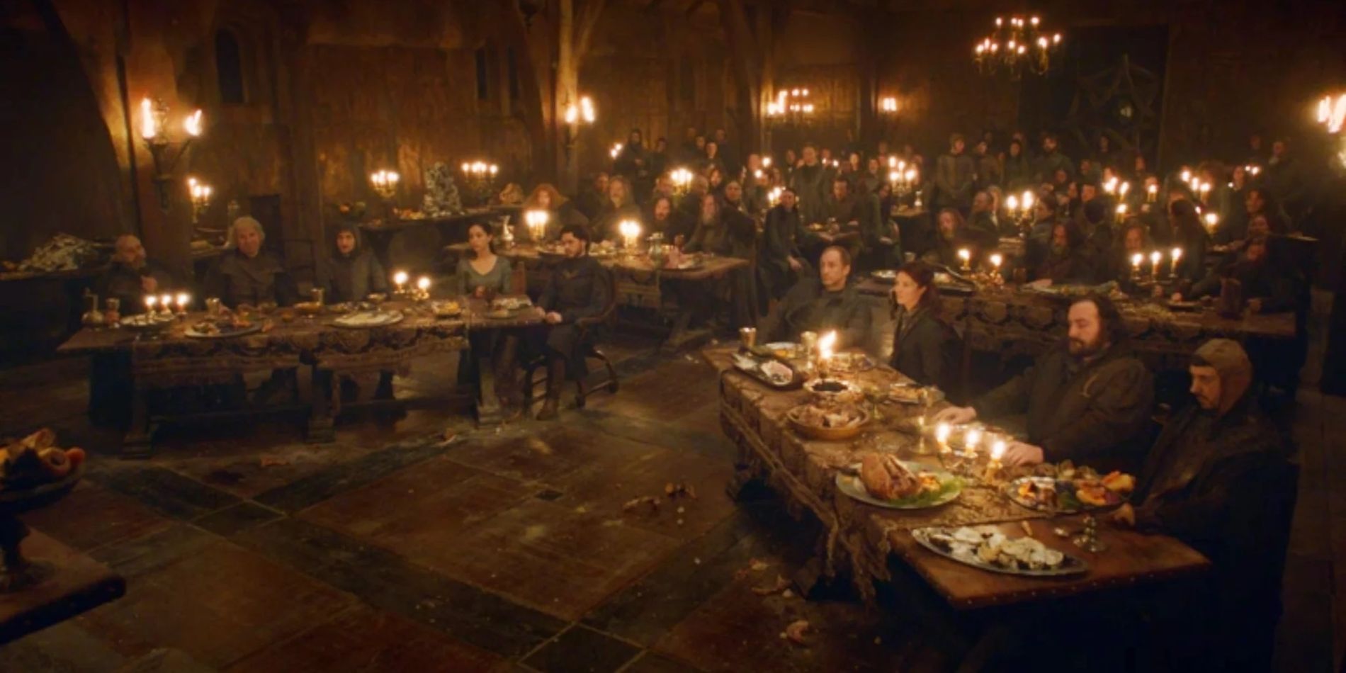 Edmure Tully's wedding feast before the Red Wedding in Game of Thrones, people are seated at tables in a great hall. 