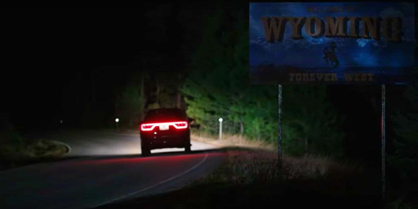 A car driving into Wyoming to the 