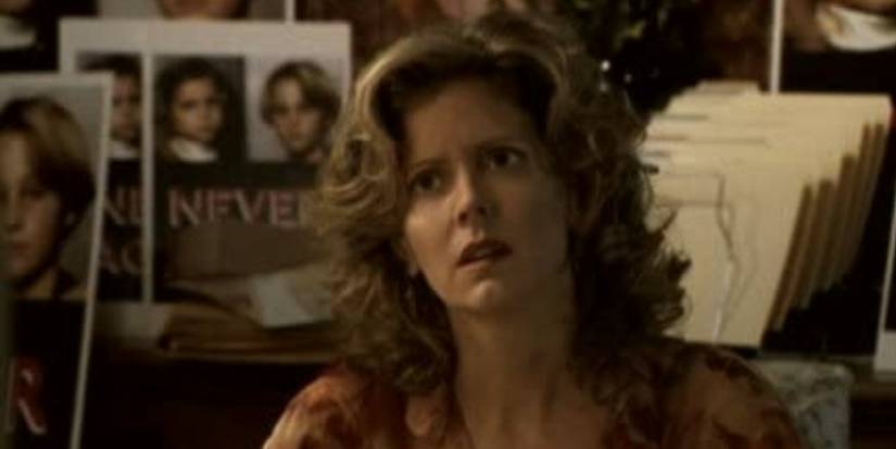 Joyce looking concerned behind posters of Hans and Greta in Buffy the Vampire Slayer