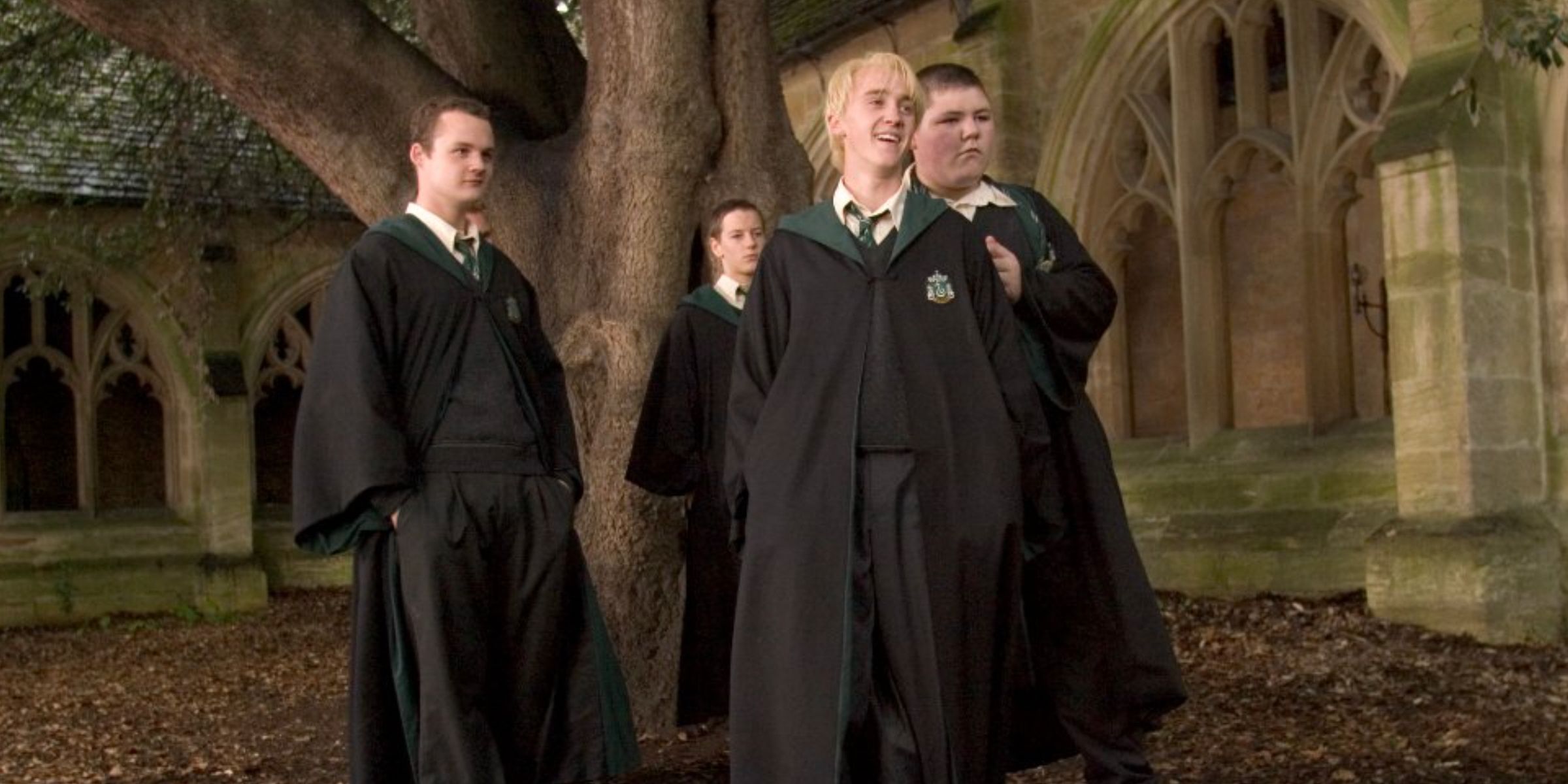 Draco Malfoy and a group of Slytherins by a tree in Harry Potter and the Goblet of Fire