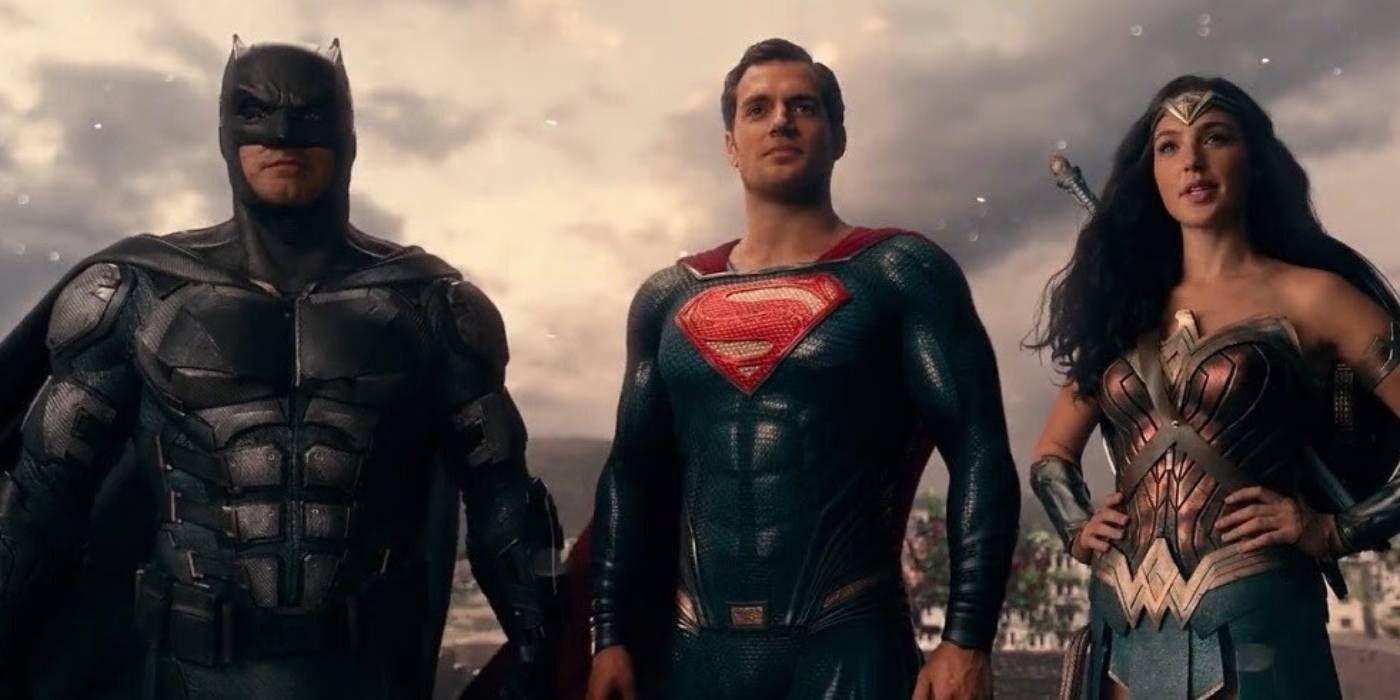 Batman, Superman, and Wonder Woman stand together triumphantly in Justice League 2017