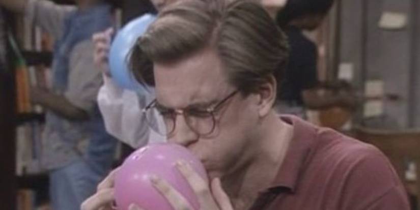 Michael Weatherly blowing up a balloon in The Cosby Show