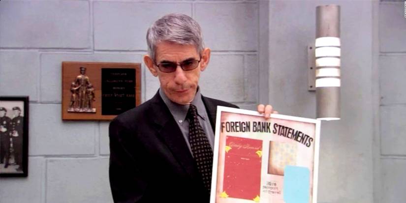Richard Belzer as John Munch holding a poster in Arrested Development