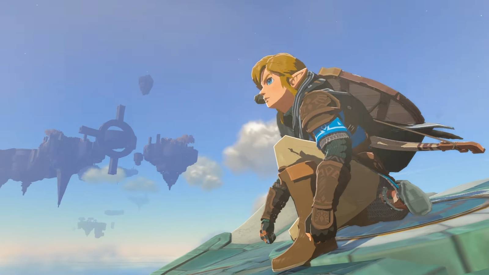 Link kneeling on the back of a stone bird in Tears of the Kingdom.
