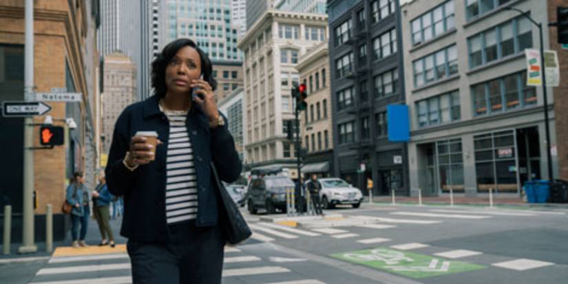 Aisha Tyler's Jules on the phone and holding a cup of coffee in New York in The Last Thing He Told Me