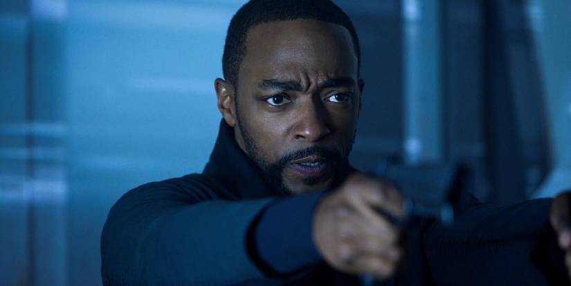 Anthony Mackie as Takeshi Kovacs pointing a gun at something off-screen in Altered Carbon season 2.