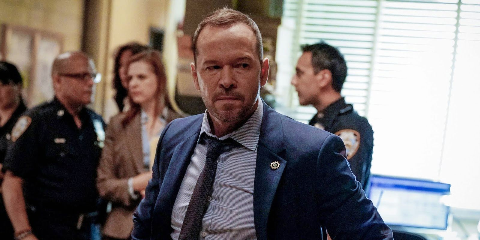 Donnie Wahlberg as Danny looking furious with people talking in the background on Blue Bloods