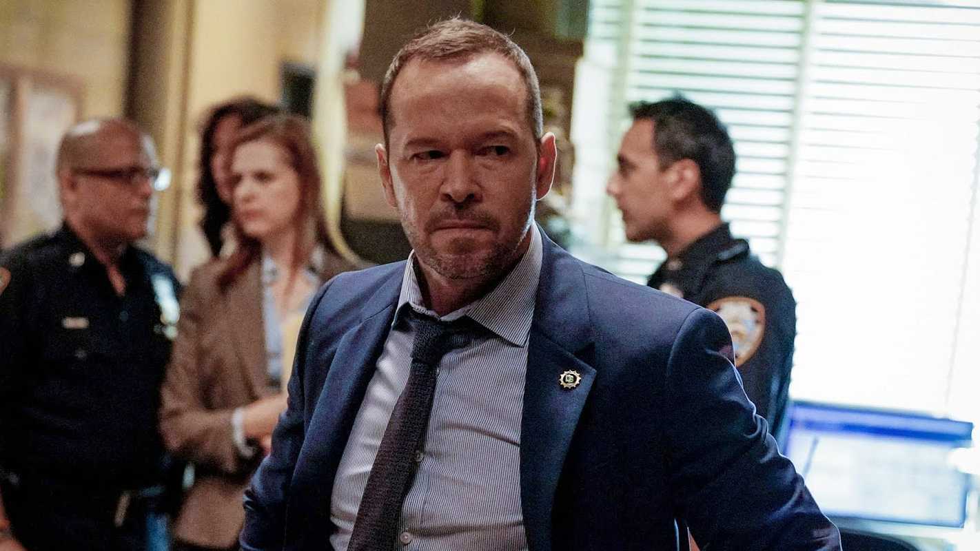 Donnie Wahlberg as Danny looking furious with people talking in the background on Blue Bloods