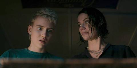 Danny and Beth looking worried at something in Evil Dead Rise
