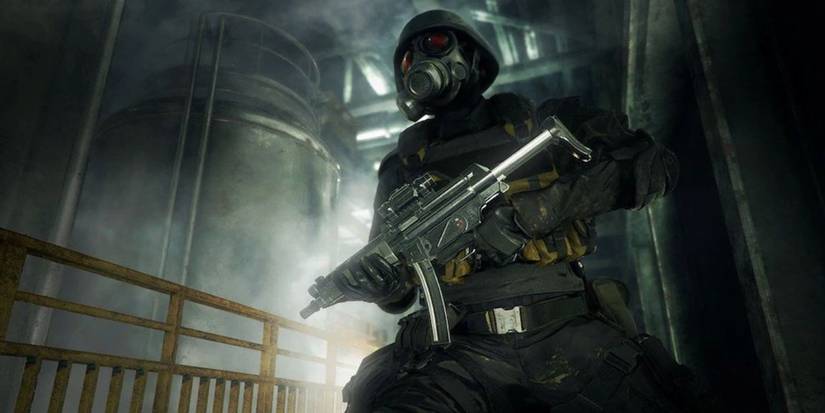 Hunk from the Resident Evil 2 remake, holding an SMG at the ready in an industrial setting.