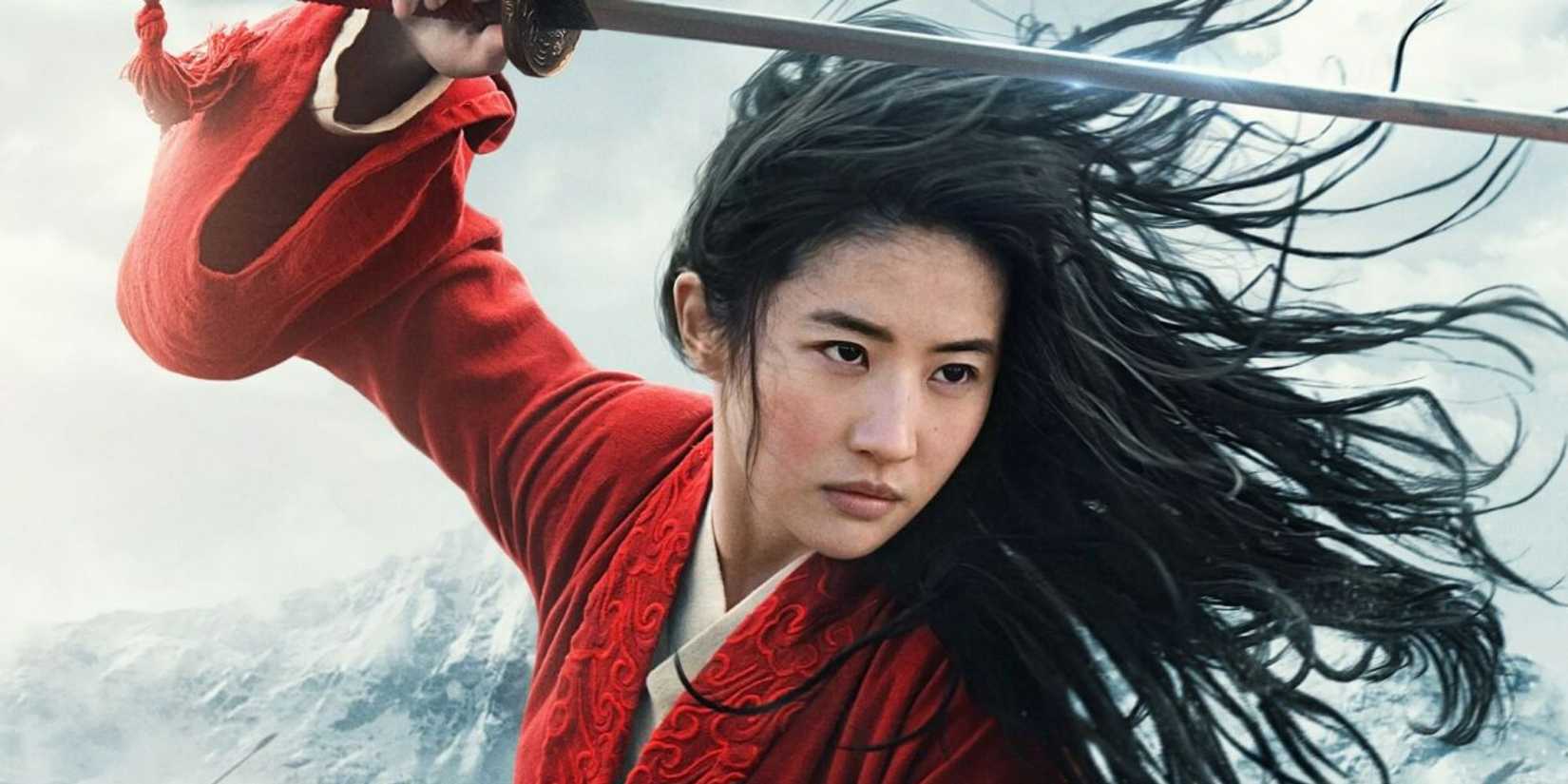 Mulan looks on blankly while brandishing a sword in the live-action version of Mulan